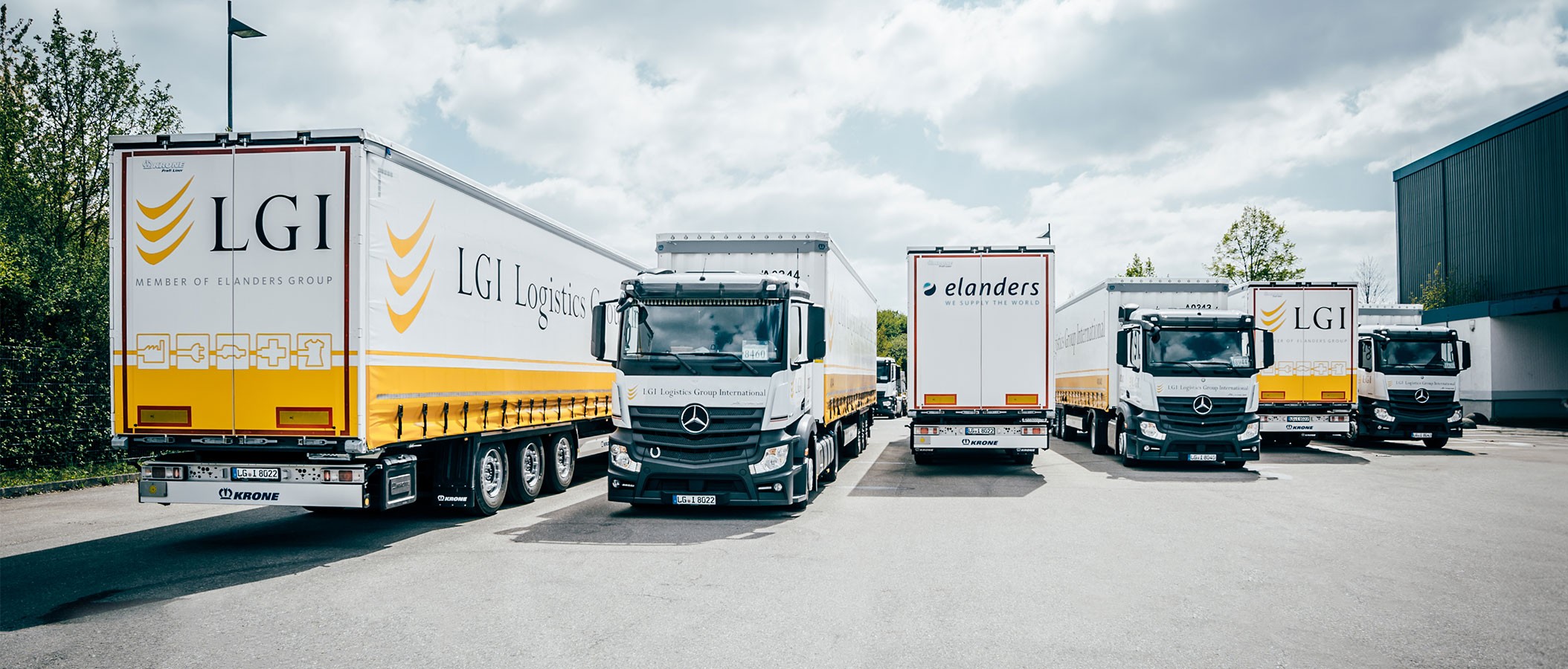 LGI company image showing six LGI branded trucks in a row next to a warehouse ©LGI
