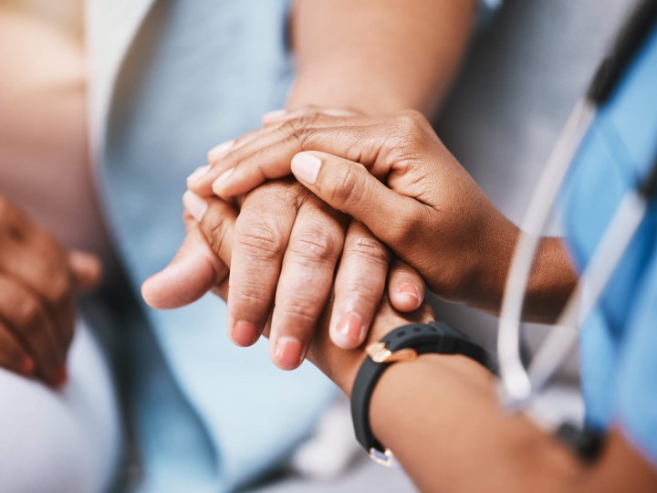 Doctor’s holding patient hand