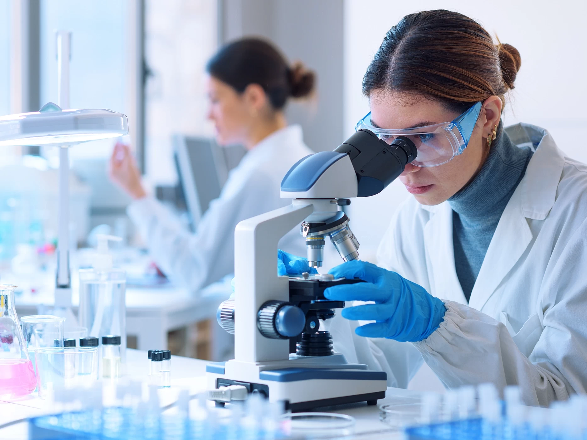 Scientist examining a sample under a microscope in a laboratory