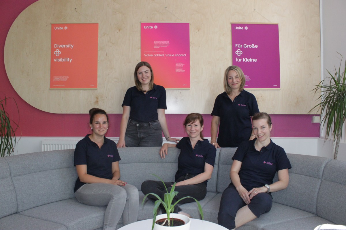 Group picture with five women standing and sitting