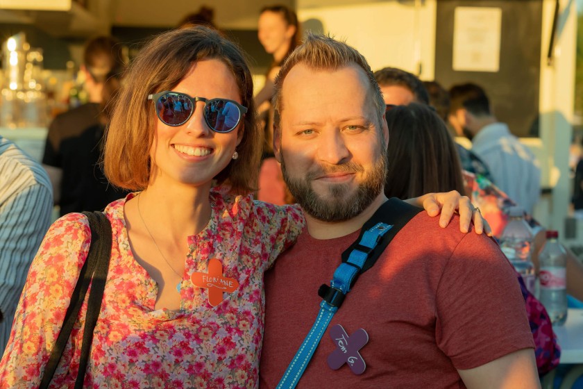 Portrait of a woman with sunglasses and a man smiling in the golden hour light