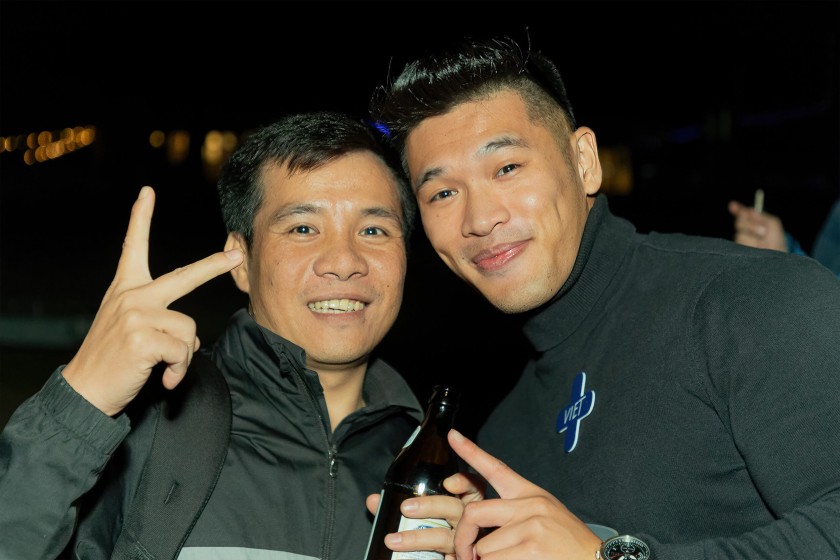 Two men from Vietnam celebrating at nighttime