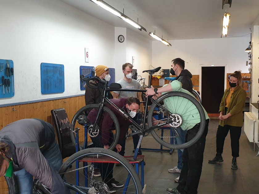 Unitees in bike workshop repairing bicycle