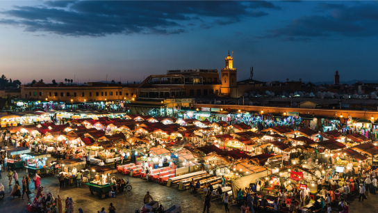 Night market with bright lights and crowded stalls